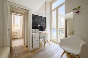 a room with a desk and a chalkboard on the wall at Vespa Apartment in Naples