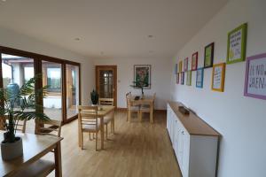 a living room with a table and a dining room at Acarsaid B&B in Lybster