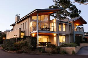 a large house with a lot of windows at Grand Mercure The Vintage in Pokolbin