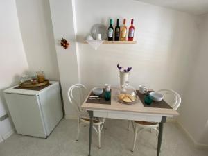 a table with a plate of food and bottles of wine at A Casa di Anna in Mamoiada