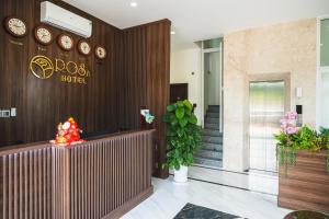 a lobby of a hotel with clocks on the wall at City Center Rosa Hotel in Phu Quoc