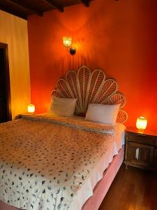 a bedroom with a bed with an orange wall at Villa Özdilek in Sapanca +37 photos