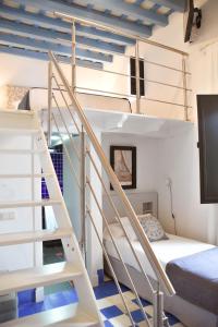 a room with a bunk bed and a staircase at Hostal Casa Alborada in Conil de la Frontera