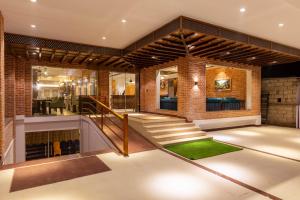 a house with a staircase and a brick wall at Dream International Hotel in Lumbini