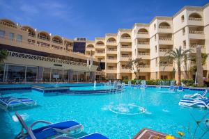 a large swimming pool in a hotel room at AMC Royal Hotel & Spa in Hurghada