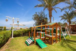 a playground with a slide and a swing set at AMC Royal Hotel & Spa in Hurghada