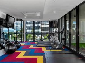 a fitness room with a gym with a colorful carpet at Koko luxury apartment in Broadbeach in Gold Coast