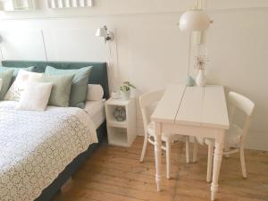 a bedroom with a bed and a table and chairs at guestroom traza 37 in Amsterdam