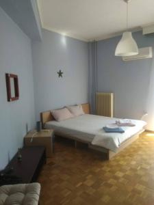 a bedroom with a bed and a couch in it at Square 2 in Komotini