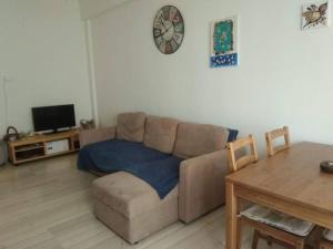 a living room with a couch and a table at Square 2 in Komotini