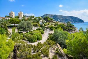 a view of a beach with trees and the ocean at Casa Sant Vicent 63 in Teulada