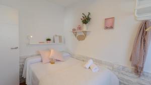 two beds in a room with white walls at Casa Serrano Cártama by Ruralidays in Cártama +24 photos