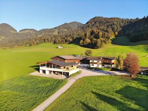 an aerial view of a house in a green field at Pension Schusterhof in Itter