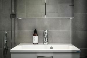 a bottle of wine sitting on a sink in a bathroom at Rauma City Center Studios in Rauma