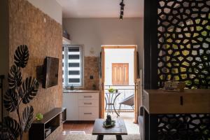 a kitchen and living room with a table in a room at Green Symi Apartment in Symi +8 photos