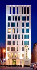 a tall white building with a lot of windows at Fu Lyu Inn in Hualien City