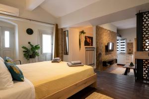 a bedroom with a large bed and a fireplace at Green Symi Apartment in Symi