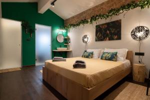 a bedroom with a large bed with green walls at Green Symi Apartment in Symi