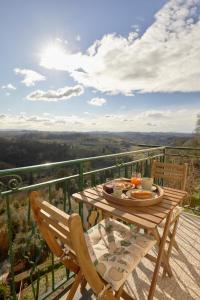 a table and chairs on a balcony with a view at Cozy apartment with a view in San Miniato in San Miniato