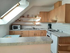 a kitchen with a sink and a stove top oven at Aan het Singelhof - Bellefleur*** met sunshower en tuin in Sint-Truiden