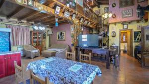 a living room with a table and a piano at Casa El Secanillo Loja by Ruralidays in Loja