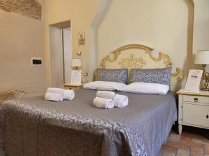a bedroom with a bed with two pillows on it at Casa Aurora in Ravenna +122 photos