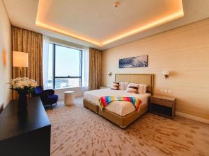 a hotel room with a bed and a large window at ORION in Dubai