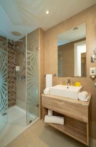 a bathroom with a sink and a shower at TUI MAGIC LIFE Penelope Beach - Families & Couples in Midoun