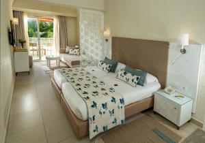 a bedroom with a bed and a living room at TUI MAGIC LIFE Penelope Beach - Families & Couples in Midoun