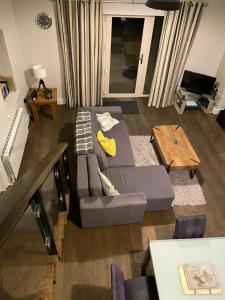 a living room with a couch and a table at Dream Cottage in Castletownbere