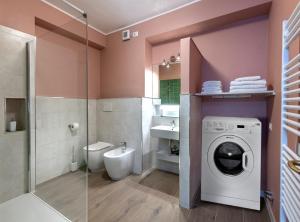 a bathroom with a washing machine and a toilet at Il Nido del Belocchio in Perugia +21 photos