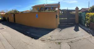 a yellow fence in front of a house at Casa Vacanze Sunflower in Carrara