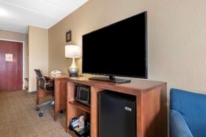 a flat screen tv sitting on top of a wooden cabinet at Comfort Inn & Suites Orlando North in Sanford