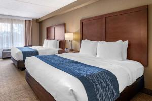 a hotel room with two large beds and a window at Comfort Inn & Suites Orlando North in Sanford