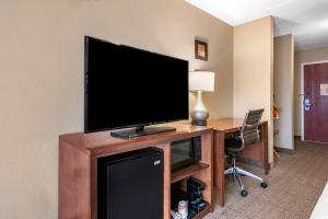 a flat screen tv sitting on a desk in a hotel room at Comfort Inn & Suites Orlando North in Sanford