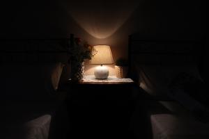 a lamp sitting on a table in a dark room at La Cascina Nel Bosco in Faicchio