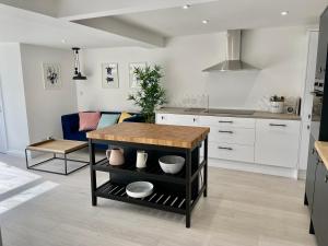 a kitchen with a table in the middle of a room at Island House in West Mersea