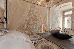 Posteľ alebo postele v izbe v ubytovaní Suite21 - The Trulli Experience
