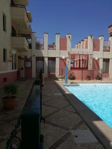 a swimming pool in front of a building at Arinaga Beach & Pool Apartment in Arinaga