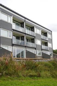 an apartment building with balconies on the side of it at Ustedalen Resort Leiligheter in Geilo
