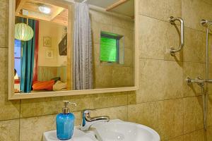 a bathroom with a sink and a mirror at Lavender Circus Hostel, Doubles & Ensuites in Budapest +50 photos
