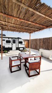 an outdoor dining area with chairs, tables and umbrellas at Caravana Beach Resort Al Zorah in Ajman 