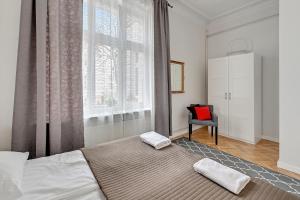a bedroom with a large bed and a window at Atelier Apartment Centrum by Grand Apartments in Sopot