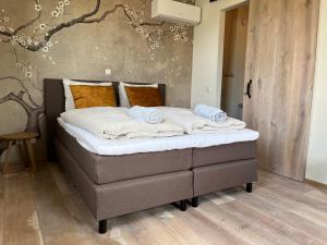 Een bed of bedden in een kamer bij De Hoogstam