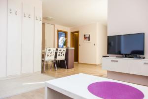 a living room with a flat screen tv and a living room at Sky Apartments in Blagoevgrad