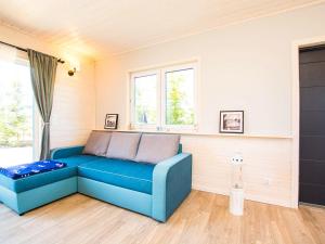 a blue couch in a room with a window at Domki Całoroczne Klif Ustka - Nowoczesne Dwupoziomowe Domki Nad Morzem in Ustka +76 photos
