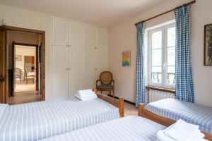 a bedroom with two beds and a window at Il Giardino del Sole - Lavanda in Garlenda +13 photos