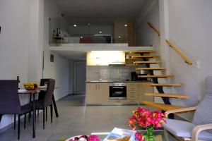 a living room and kitchen with a staircase in a house at Erinaki Apartments in Kissamos