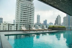 a swimming pool on the roof of a building at Circle Sukhumvit 11#Luxury#Pool#Gym#BTS Nana&MRT Sukhumvit#1BR#Max2ppl in Bangkok