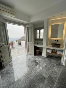 a bathroom with a view of the ocean at Smaro Studios in Firostefani